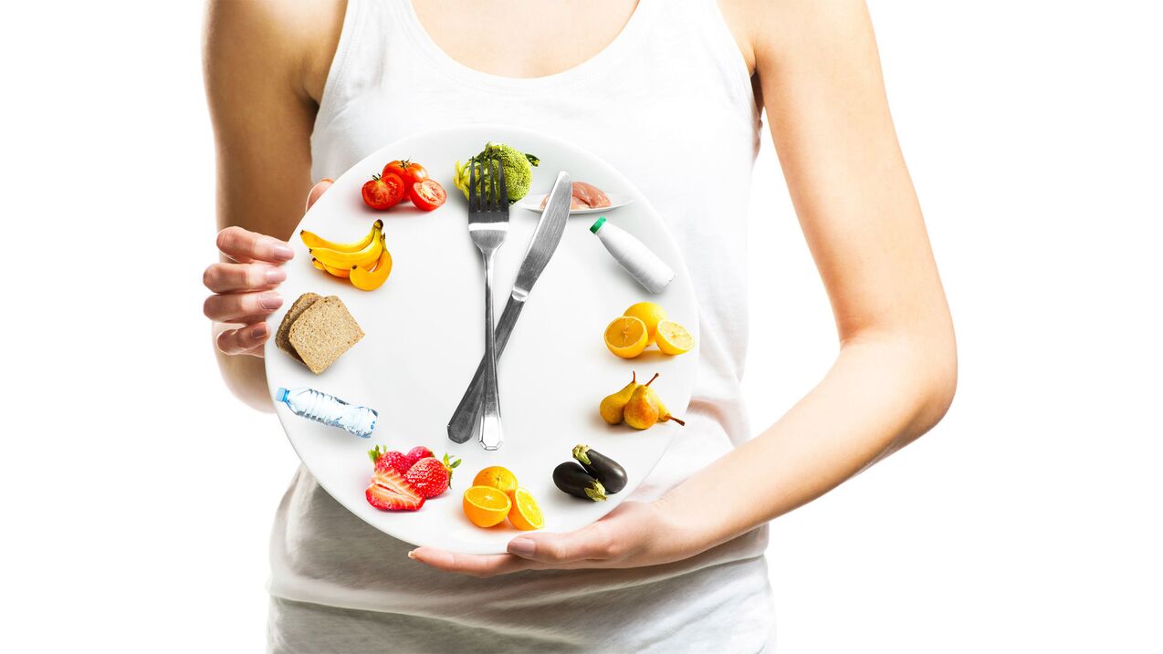 The girl holds the food plate